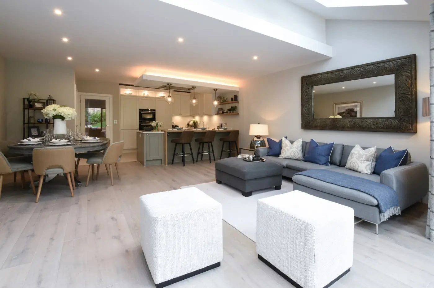 Open plan living space that is very modern, dining, living and kitchen area. The decor is very modern. 